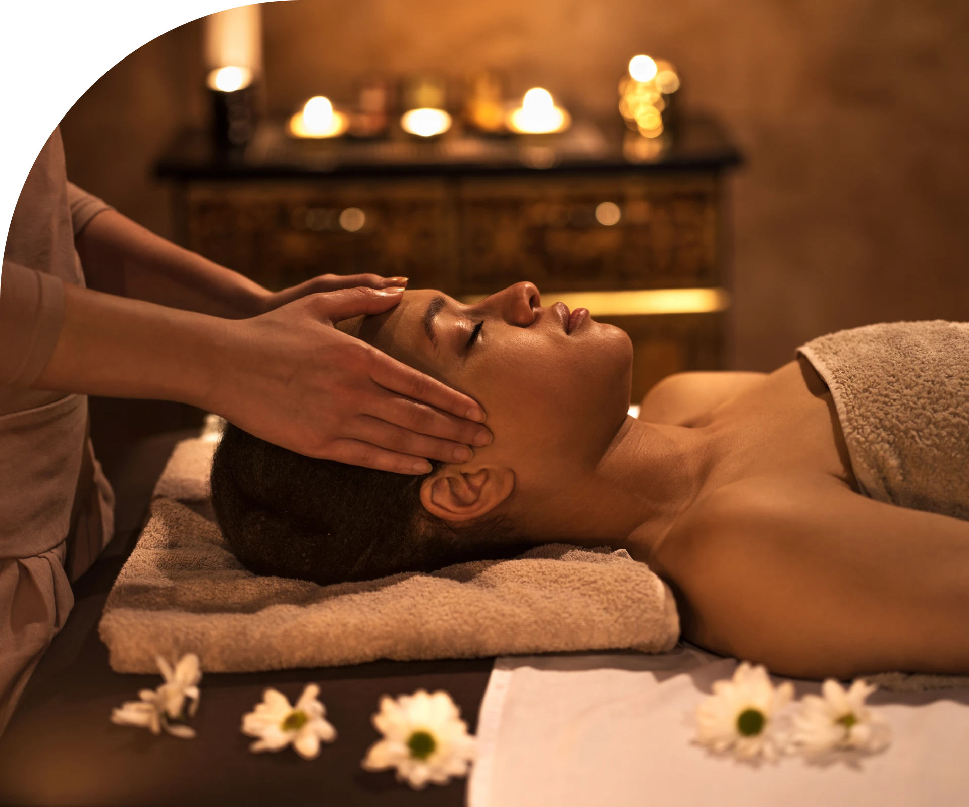 Spa massage with candles and flowers